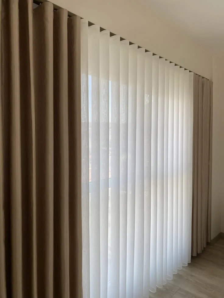 Wave sheer and blackout curtains on a double track, Dubai