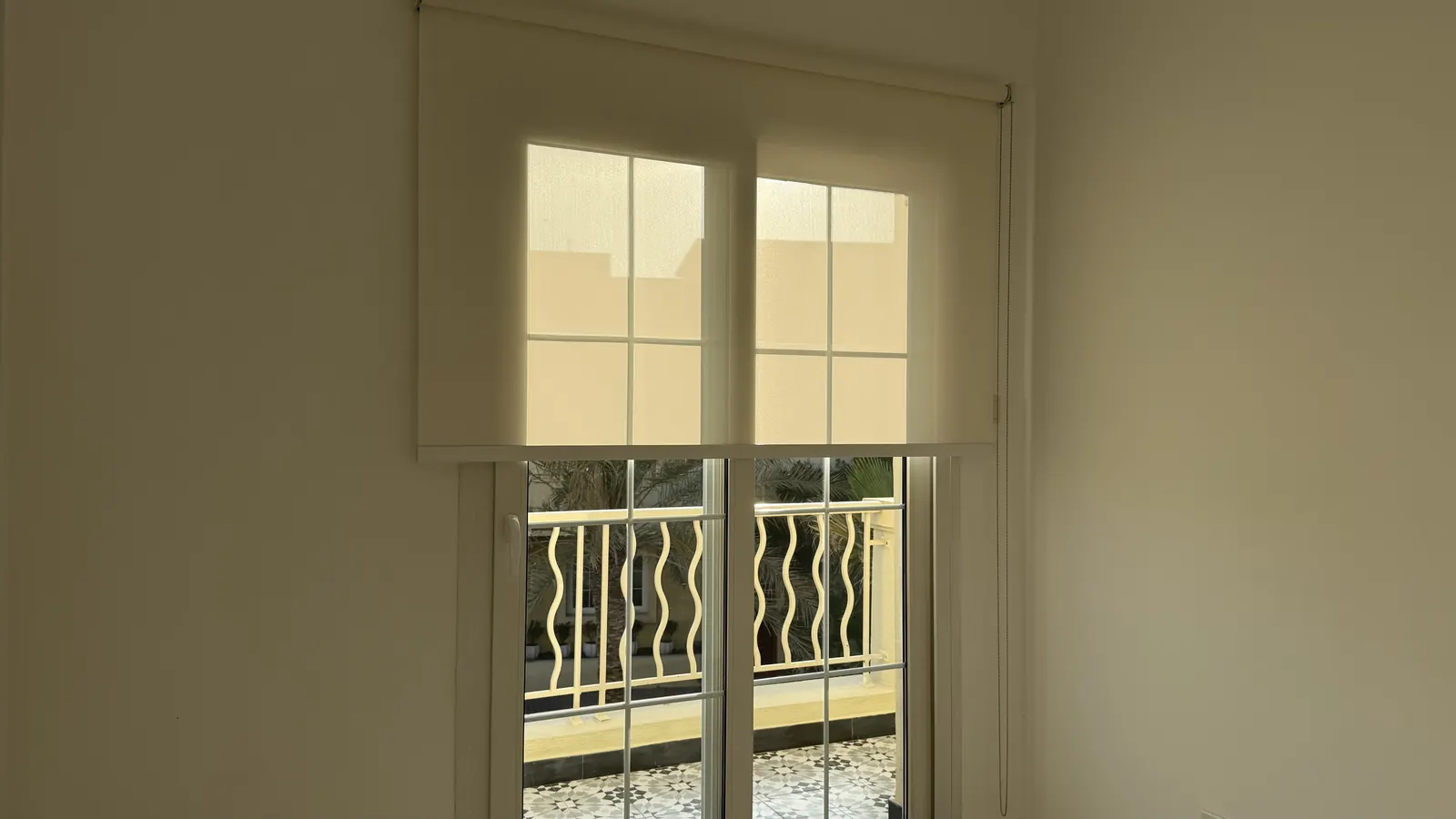 White roller blinds on a double window, Dubai